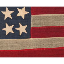 38 STAR ANTIQUE AMERICAN FLAG IN A TINY SCALE AMONG THOSE WITH PIECED-AND-SEWN CONSTRUCTION, WITH A BEAUTIFUL & UNUSUAL SHADE OF BLUE AND WITH A NOTCHED CONFIGURATION OF STARS THAT LEAVES ROOM FOR WESTERN TERRITORIES THAT HAD YET TO BE ADDED; REFLECTS THE PERIOD WHEN COLORADO WAS THE MOST RECENT STATE TO JOIN THE UNION, 1876-1889
