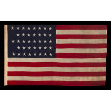 38 STAR ANTIQUE AMERICAN FLAG WITH A NOTCHED CONFIGURATION, MADE BY THE U.S. BUNTING COMPANY IN LOWELL, MASSACHUSETTS, REFLECTS THE ERA OF COLORADO STATEHOOD, circa 1876-1889