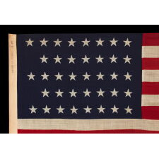 38 STAR ANTIQUE AMERICAN FLAG WITH A NOTCHED CONFIGURATION, MADE BY THE U.S. BUNTING COMPANY IN LOWELL, MASSACHUSETTS, REFLECTS THE ERA OF COLORADO STATEHOOD, circa 1876-1889