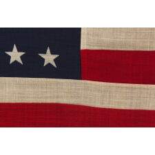 38 STAR ANTIQUE AMERICAN FLAG WITH A NOTCHED CONFIGURATION, MADE BY THE U.S. BUNTING COMPANY IN LOWELL, MASSACHUSETTS, REFLECTS THE ERA OF COLORADO STATEHOOD, circa 1876-1889