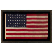 38 STAR ANTIQUE AMERICAN FLAG WITH A NOTCHED CONFIGURATION, MADE BY THE U.S. BUNTING COMPANY IN LOWELL, MASSACHUSETTS, REFLECTS THE ERA OF COLORADO STATEHOOD, circa 1876-1889