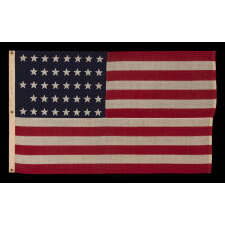 38 STAR ANTIQUE AMERICAN FLAG WITH A NOTCHED CONFIGURATION, MADE BY THE U.S. BUNTING COMPANY IN LOWELL, MASSACHUSETTS, REFLECTS THE ERA OF COLORADO STATEHOOD, circa 1876-1889