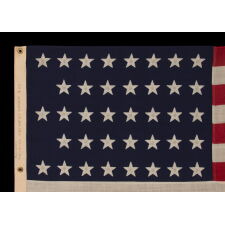 38 STAR ANTIQUE AMERICAN FLAG WITH A NOTCHED CONFIGURATION, MADE BY THE U.S. BUNTING COMPANY IN LOWELL, MASSACHUSETTS, REFLECTS THE ERA OF COLORADO STATEHOOD, circa 1876-1889