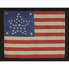 38 STAR ANTIQUE AMERICAN PARADE FLAG WITH A RARE AND BEAUTIFUL VARIATION OF THE "GREAT STAR" OR "GREAT FLOWER" AND AN ODD OUTLIER, 1876-1889, COLORADO STATEHOOD