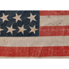 38 STAR ANTIQUE AMERICAN PARADE FLAG IN AN UNUSUALLY LARGE SCALE, WITH ENDEARING WAR FROM OBVIOUS LONG-TERM USE, AND WITH DANCING ROWS IN AN HOURGLASS FORMATION; COLORADO STATEHOOD, 1876-1889