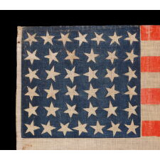 38 STAR ANTIQUE AMERICAN PARADE FLAG WITH JUSTIFIED ROWS OF 7-6-6-6-6-7 AND SCATTERED STAR ORIENTATION, MADE DURING THE PERIOD WHEN COLORADO WAS THE MOST RECENT STATE TO JOIN THE UNION, 1876-1889
