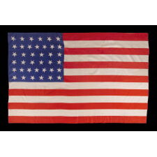 38 STAR ANTIQUE AMERICAN PARADE FLAG WITH SCATTERED STAR ORIENTATION, MADE OF SILK, WITH GENEROUS SCALE AND VIVID COLORS, COLORADO STATEHOOD, 1876-1889