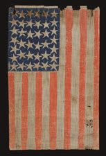 38 STAR FLAG WITH ESPECIALLY LARGE STARS AND INTERTWINED ARMS, AN ANTIQUE EXAMPLE REFLECTING COLORADO STATEHOOD, 1876-1889