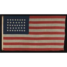 38 STAR FLAG WITH HAND-SEWN STARS, IN AN UNUSUALLY CONFINED PATTERN OF JUSTIFIED ROWS, ON AN ANTIQUE FLAG IN A SMALL SCALE FOR THE PERIOD, 1876-1889, COLORADO STATEHOOD