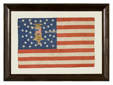 38 STAR FLAG WITH A MULTI-COLOR CIVIL WAR VETERAN'S BADGE AT THE CENTER OF A WHIMSICAL MEDALLION STAR CONFIGURATION AND ITS CANTON RESTING ON THE WAR STRIPE, COLORADO STATEHOOD, 1876-1889