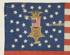 38 STAR FLAG WITH A MULTI-COLOR CIVIL WAR VETERAN'S BADGE AT THE CENTER OF A WHIMSICAL MEDALLION STAR CONFIGURATION AND ITS CANTON RESTING ON THE WAR STRIPE, COLORADO STATEHOOD, 1876-1889