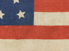 38 STAR FLAG WITH A MULTI-COLOR CIVIL WAR VETERAN'S BADGE AT THE CENTER OF A WHIMSICAL MEDALLION STAR CONFIGURATION AND ITS CANTON RESTING ON THE WAR STRIPE, COLORADO STATEHOOD, 1876-1889