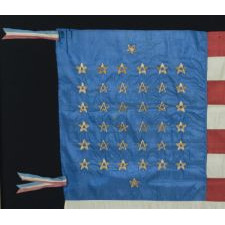 38 STAR FLAG, MADE OF SILK WITH 12 STRIPES AND THREE DIFFERENT STYLES OF HAND-EMBROIDERED STARS, ARRANGED TO REFLECT THE NUMBER OF NORTHERN AND SOUTHERN SUPPORTING STATES DURING THE CIVIL WAR, AND RESULTING IN ONE OF THE MOST RARE STAR CONFIGURATIONS EXTANT AMONG SURVIVING EXAMPLES, COLORADO STATEHOOD, 1876-1889
