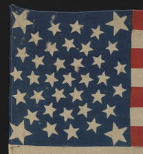 38 STARS, COLORADO STATEHOOD, A RARE MEDALLION PATTERN FLAG WITH 4 LARGE CORNER STARS, MADE FOR THE 1876 CENTENNIAL OF OUR NATION'S INDEPENDENCE, PRESS-DYED ON WOOL BUNTING