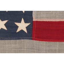 38 STARS IN CRUDE COLUMNS WITH HAPHAZARD ORIENTATION, ON AN ANTIQUE AMERICAN FLAG WITH A BEAUTIFUL, SLATE BLUE CANTON, SIGNED "LEDDON," MADE IN THE ERA WHEN COLORADO WAS THE MOST RECENT STATE TO JOIN THE UNION, 1876-1889
