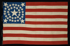 38 STARS IN A DOUBLE-WREATH WITH A HUGE CENTER STAR, WITH A BRILLIANT ROYAL BLUE CANTON, ON A SEWN FLAG WITH ESPECIALLY SMALL SCALE FOR THE 19TH CENTURY, 1876-1889, COLORADO STATEHOOD