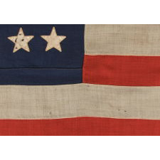 38 STARS WITH ENDEARING WEAR ON AN UNUSUALLY SMALL PIECED-AND SEWN ANTIQUE AMERICAN FLAG OF THE 1876-1889 PERIOD, REFLECTS COLORADO'S ADDITION TO THE UNION