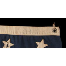38 STARS WITH ENDEARING WEAR ON AN UNUSUALLY SMALL PIECED-AND SEWN ANTIQUE AMERICAN FLAG OF THE 1876-1889 PERIOD, REFLECTS COLORADO'S ADDITION TO THE UNION