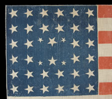 38 STARS IN AN EXTREMELY RARE LINEAL CONFIGURATION WITH 4 TINY STARS EMBEDDED IN THE PATTERN, EITHER MADE BETWEEN 1876-1889 (COLORADO STATEHOOD) OR PERHAPS IN THE 34 STAR PERIOD (1861-63), WITH 4 SMALL STARS FOR THE REMAINING TERRITORIES