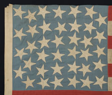 38 STARS IN AN INTERTWINED "DOUBLE-S" CONFIGURATION, ON A CORNFLOWER BLUE CANTON THAT RESTS UPON THE WAR STRIPE, 1876-1889, COLORADO STATEHOOD