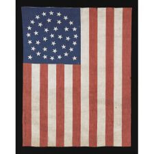 38 STARS IN A MEDALLION CONFIGURATION WITH 2 OUTLIERS, A RARE EXAMPLE OF THIS PATTERN ON A LARGE SCALE PARADE FLAG WITH RED STRIPES, 1876-1889, COLORADO STATEHOOD