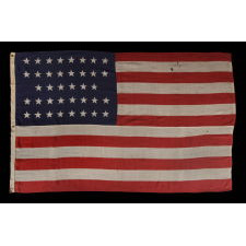 38 STARS IN A "NOTCHED" PATTERN ON A 7 ft. CLAMP-DYED AMERICAN FLAG OF THE 1876-1889 PERIOD, REFLECTS COLORADO STATEHOOD, MADE BY THE U.S. BUNTING COMPANY IN LOWELL, MASSACHUSETTS