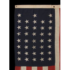 38 STARS IN A "NOTCHED" PATTERN ON A CLAMP-DYED AMERICAN FLAG OF THE 1876-1889 PERIOD, REFLECTS COLORADO STATEHOOD, MADE BY THE U.S. BUNTING COMPANY IN LOWELL, MASSACHUSETTS​