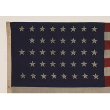 38 STARS IN A "NOTCHED" PATTERN ON A CLAMP-DYED AMERICAN FLAG OF THE 1876-1889 PERIOD, REFLECTS COLORADO STATEHOOD, MADE BY THE U.S. BUNTING COMPANY IN LOWELL, MASSACHUSETTS