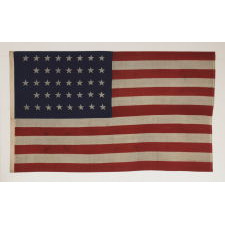 38 STARS IN A "NOTCHED" PATTERN ON A CLAMP-DYED AMERICAN FLAG OF THE 1876-1889 PERIOD, REFLECTS COLORADO STATEHOOD, MADE BY THE U.S. BUNTING COMPANY IN LOWELL, MASSACHUSETTS