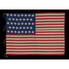 38 STARS AND A VERY UNUSUAL COMPLEMENT OF 31 STRIPES, ON AN ANTIQUE AMERICAN FLAG MADE DURING THE PERIOD WHEN COLORADO WAS THE MOST RECENT STATE TO JOIN THE UNION, 1876-1889, WITH STUNNING GRAPHICS AND COLORS, ONE-OF-A-KIND AMONG KNOWN EXAMPLES