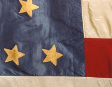 44 STAR ANTIQUE AMERICAN FLAG, MADE OF SILK, WITH GILT-PAINTED STARS & LETTERS THAT DESIGNATE A CHAPTER OF THE JUNIOR ORDER OF UNITED AMERICAN MECHANICS, A PATRIOTIC FRATERNAL ORGANIZATION FOUNDED IN PHILADELPHIA, PENNSYLVANIA IN 1853; MADE DURING THE PERIOD WHEN WYOMING WAS THE MOST RECENT STATE TO JOIN THE UNION, circa 1890-1896