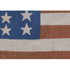 39 STARS IN TWO SIZES, ALTERNATING FROM ONE COLUMN TO THE NEXT, ON AN ANTIQUE AMERICAN PARADE FLAG WITH AN UNUSUALLY ELONGATED PROFILE, DATING TO THE 1876 CENTENNIAL, NEVER AN OFFICIAL STAR COUNT, REFLECTS THE ANTICIPATED ARRIVAL OF COLORADO AND THE DAKOTA TERRITORY
