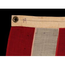 42 HAND-SEWN STARS ON AN ANTIQUE AMERICAN FLAG WITH A DUSTY BLUE CANTON; AN UNOFFICIAL STAR COUNT THAT REFLECTS THE ADDITION OF WASHINGTON STATE, MONTANA, AND THE DAKOTAS, circa 1889-1890