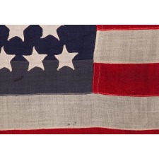 44 STAR ANTIQUE AMERICAN FLAG WITH AN HOURGLASS ARRANGEMENT ON A TWO-TONE BLUE CANTON; REFLECTS THE ERA WHEN WYOMING WAS THE MOST RECENT STATE TO JOIN THE UNION, 1890-1896