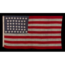 44 STAR ANTIQUE AMERICAN FLAG WITH AN HOURGLASS ARRANGEMENT ON A DUSTY BLUE CANTON; REFLECTS THE ERA WHEN WYOMING WAS THE MOST RECENT STATE TO JOIN THE UNION, 1890-1896