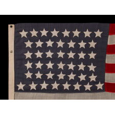 44 STAR ANTIQUE AMERICAN FLAG WITH AN HOURGLASS ARRANGEMENT ON A DUSTY BLUE CANTON; REFLECTS THE ERA WHEN WYOMING WAS THE MOST RECENT STATE TO JOIN THE UNION, 1890-1896