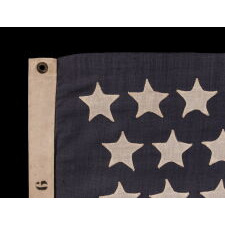 44 STAR ANTIQUE AMERICAN FLAG WITH AN HOURGLASS ARRANGEMENT ON A DUSTY BLUE CANTON; REFLECTS THE ERA WHEN WYOMING WAS THE MOST RECENT STATE TO JOIN THE UNION, 1890-1896