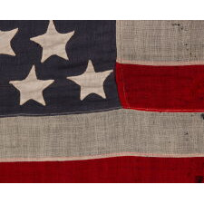 44 STAR ANTIQUE AMERICAN FLAG WITH AN HOURGLASS ARRANGEMENT ON A DUSTY BLUE CANTON; REFLECTS THE ERA WHEN WYOMING WAS THE MOST RECENT STATE TO JOIN THE UNION, 1890-1896