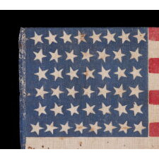 44 STAR ANTIQUE AMERICAN FLAG WITH AN HOURGLASS FORMATION ON A BRILLIANT BLUE CANTON; REFLECTS THE ERA WHEN WYOMING WAS THE MOST RECENT STATE TO JOIN THE UNION, 1890-1896