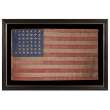 44 STAR ANTIQUE AMERICAN PARADE FLAG WITH A CORNFLOWER BLUE CANTON, ITS STARS ARRANGED IN A NOTCHED PATTERN, AND WITH A KEENLY ENDEARING PRESENTATION, 1890-1896, WYOMING STATEHOOD