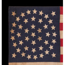 44 STAR ANTIQUE AMERICAN PARADE FLAG WITH A TRIPLE WREATH FORM OF THE MEDALLION CONFIGURATION, RARE IN THIS PERIOD WITH A CIRCULAR STAR ARRANGEMENT, 1890-1896, REFLECTS THE ADDITION OF WYOMING TO THE UNION