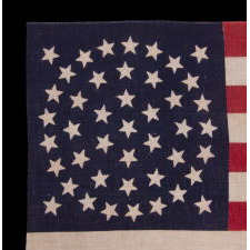 44 STAR ANTIQUE AMERICAN PARADE FLAG WITH A TRIPLE WREATH FORM OF THE MEDALLION CONFIGURATION, RARE IN THIS PERIOD WITH A CIRCULAR STAR ARRANGEMENT, 1890-1896, REFLECTS THE ADDITION OF WYOMING TO THE UNION