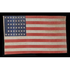 44 STARS IN A NOTCHED PATTERN ON A LARGE AMERICAN PARADE FLAG WITH A PENCILED INSCRIPTION FROM A CELEBRATION OF JULY 4TH IN NORTH DAKOTA, 1890-1896, REFLECTS WYOMING STATEHOOD, EX-RICHARD PIERCE COLLECTION