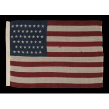 44 STARS IN ZIGZAGGING ROWS ON A PRESS-DYED WOOL AMERICAN FLAG, PROBABLY MADE BY THE HORSTMANN COMPANY IN PHILADELPHIA, POSSIBLY FOR USE AS A MILITARY CAMP COLORS, 1890-1896, REFLECTS WYOMING STATEHOOD