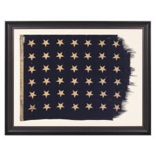 48 STAR U.S. NAVY JACK, MARKED AS HAVING BEEN FLOWN ON THE U.S.S. FT. MANDAN, LAUNCHED NEAR THE END OF WWII, IN 1945, WITH SERVICE DURING BOTH THE KOREAN AND VIETNAM WAR ERAS, IN THE ARCTIC, AT THE NORTH POLE, AND AT GUANTANAMO BAY DURING THE CUBAN MISSILE CRISIS; FLOWN DURING THE EARLIEST POINT OF THE SHIP’S SERVICE, THE FLAG EXHIBITS ENDEARING WEAR FROM OBVIOUS USE