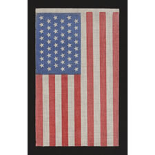48 STARS IN STAGGERED ROWS ON AN ANTIQUE AMERICAN FLAG WITH A ROYAL BLUE CANTON, AN UNOFFICIAL CONFIGURATION FOR THIS STAR COUNT, 1912-1918