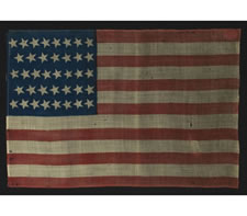 38 STARS, COLORADO STATEHOOD, A PRESS-DYED WOOL FLAG MADE FOR THE 1876 CENTENNIAL INTERNATIONAL EXPOSITION IN PHILADELPHIA AND SOLD BY HORSTMANN BROTHERS