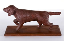 HAND-CARVED, WOODEN SETTER OR SPANIEL DOG WITH RED PAINTED SURFACE, CA 1920-40