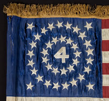 RARE AND BEAUTIFUL 38 STAR FLAG, AN INDIAN WARS PERIOD FLANK GUIDON OF THE 4th U.S. INFANTRY, WITH A MEDALLION CONFIGURATION SURROUNDING THE NUMERAL "4".  1876-1889, COLORADO STATEHOOD