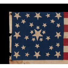 ANTIQUE AMERICAN FLAG MADE FOR THE 1860 PRESIDENTIAL CAMPAIGN OF ABRAHAM LINCOLN & HANNIBAL HAMLIN, WITH 31 STARS IN A FANCIFUL STARBURST OR ‘GREAT STAR-IN-A-SQUARE’ MEDALLION; ONE OF THE RAREST AND MOST GRAPHIC OF ALL CONFIGURATIONS THAT HAVE BEEN IDENTIFIED IN 19TH CENTURY EXAMPLES; THE ONLY KNOWN LINCOLN CAMPAIGN FLAG IN THIS STYLE, AND ONE OF JUST 3 PARADE FLAGS OF ANY SORT THAT SHARE THIS SPECTACULAR STAR ARRANGEMENT
